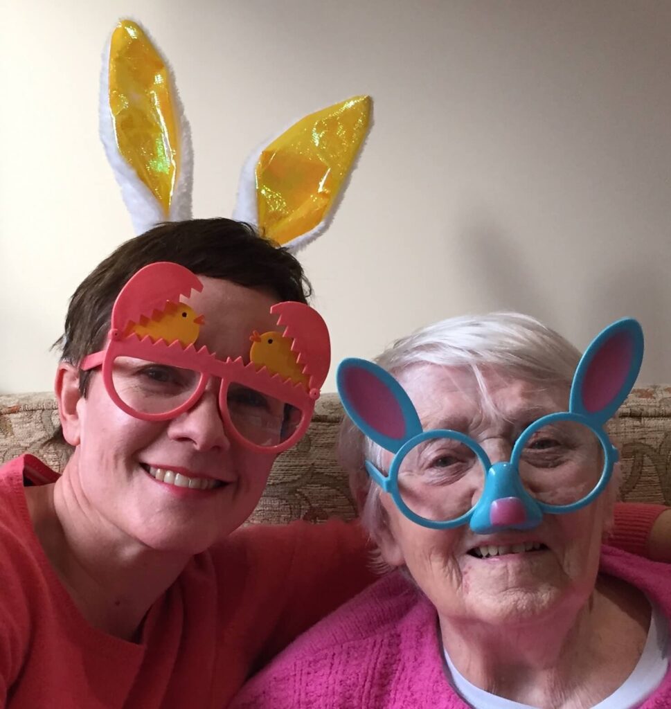 Easter picture of two ladies in bunny ears head bands.