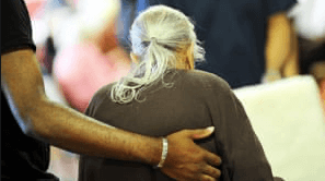 older lady being helped to walk