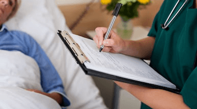 nurse completing a patients notes
